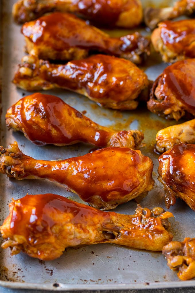 Slow cooker chicken drumsticks on a sheet pan, ready for the broiler.