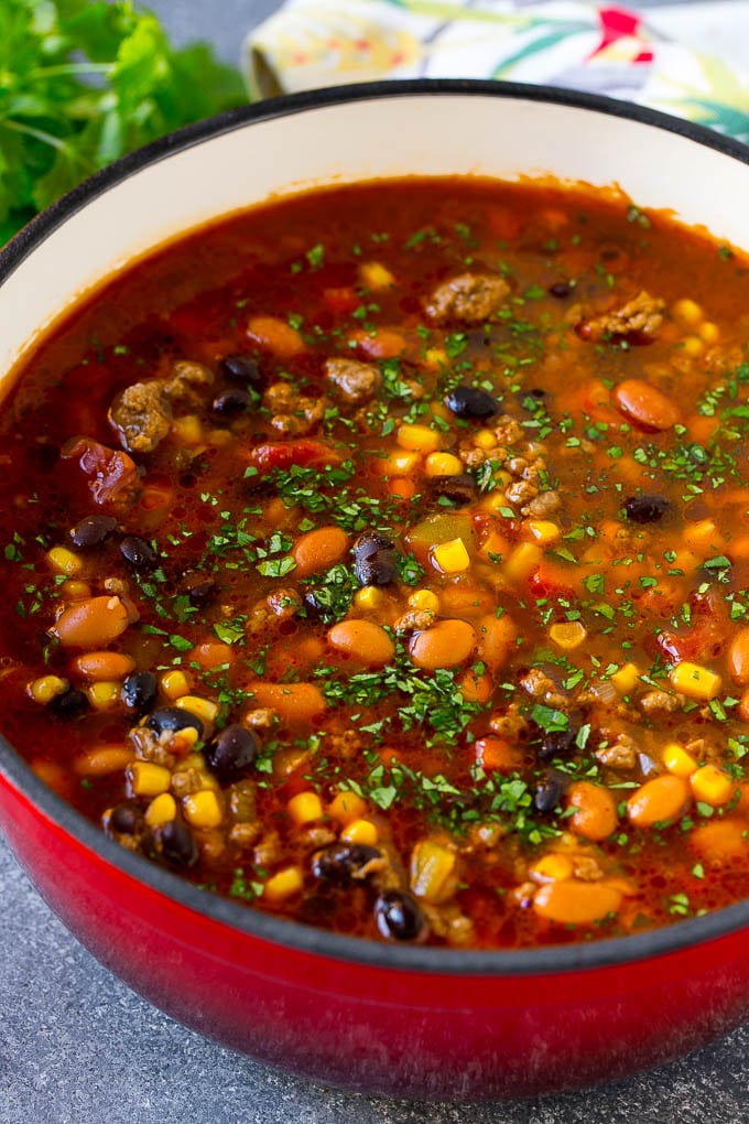 A pot of taco soup with ground beef, peppers, onions, corn, tomatoes and two types of beans.