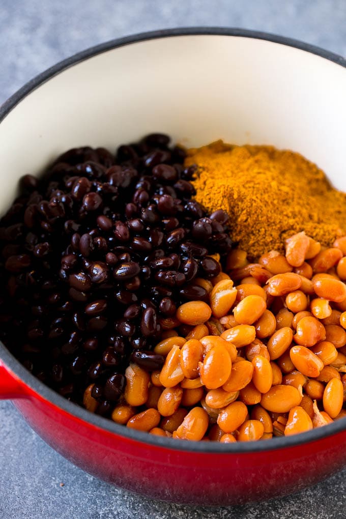 Ground beef, black beans, pinto beans and taco seasoning in a pot.