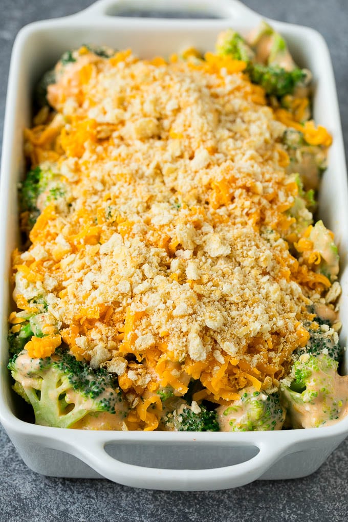 Broccoli in cheese sauce topped with crushed crackers and shredded cheese.