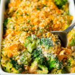 A pan of broccoli casserole with a serving spoon in it.