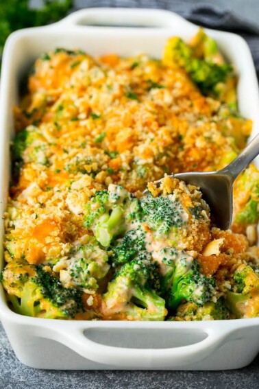 A pan of broccoli casserole with a serving spoon in it.