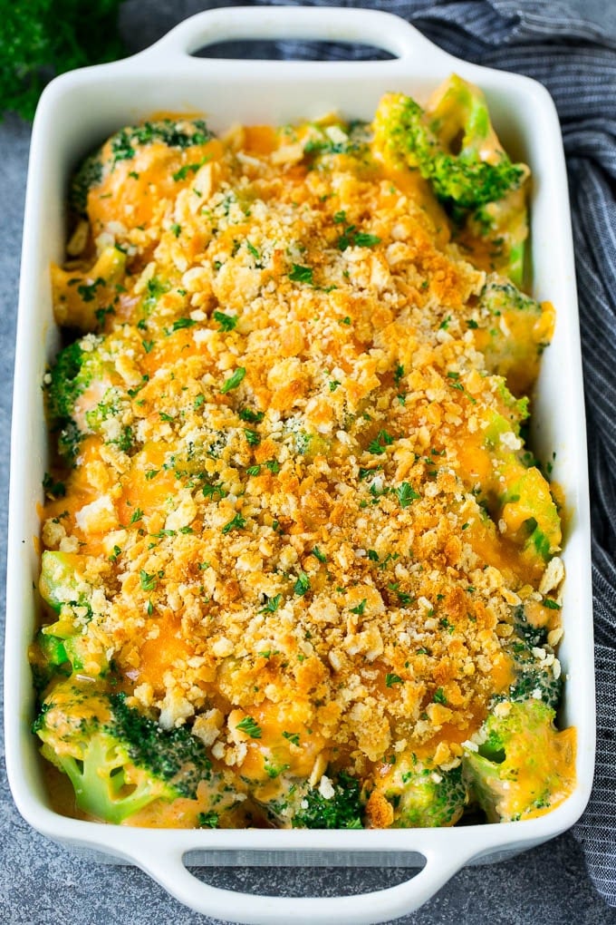 Broccoli Casserole Recipe | Broccoli and Cheese Casserole | Baked Broccoli #broccoli #cheese #casserole #sidedish #dinner #dinneratthezoo A pan of broccoli casserole topped with crackers, melted cheese and parsley.