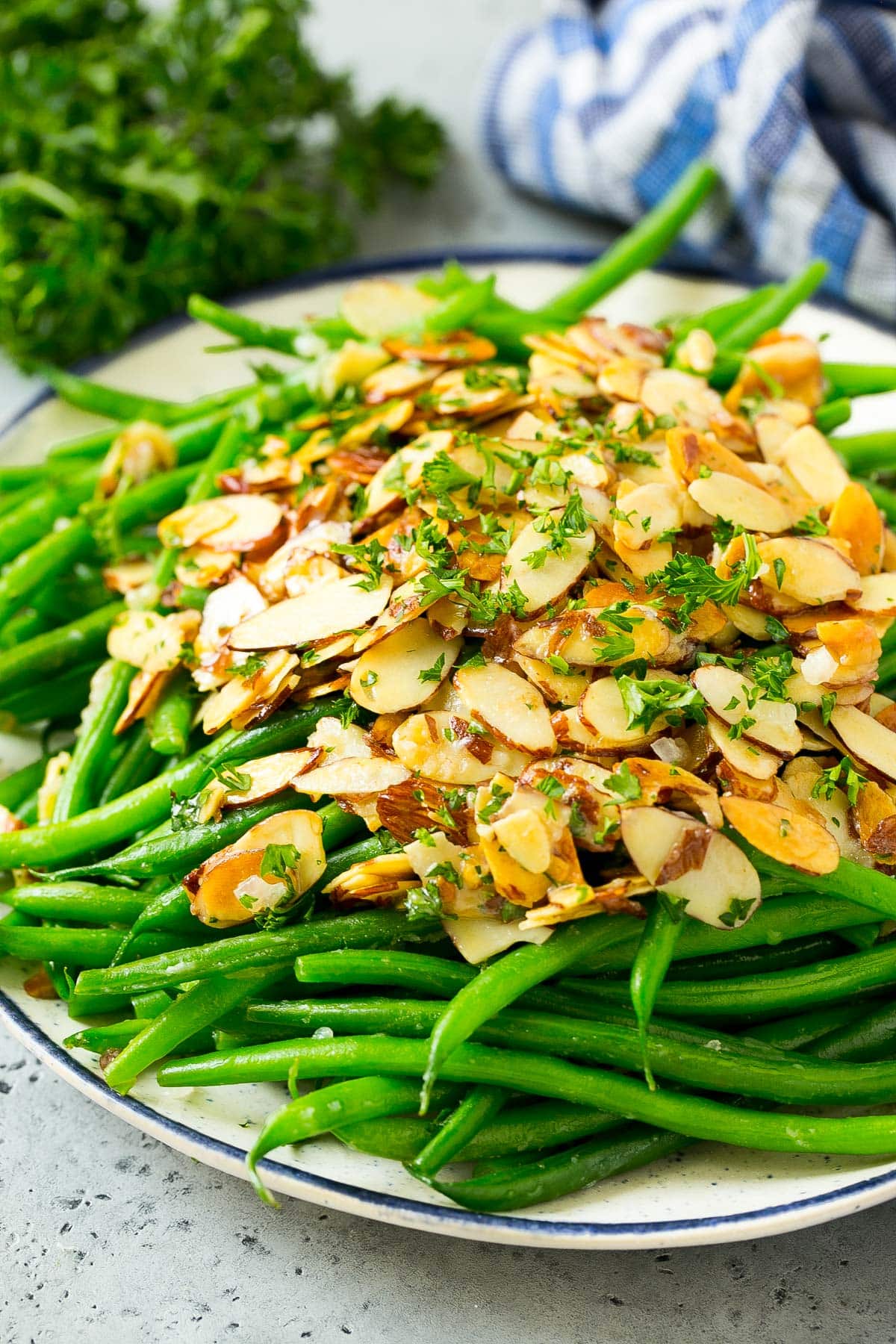 A serving plate of green beans almondine.