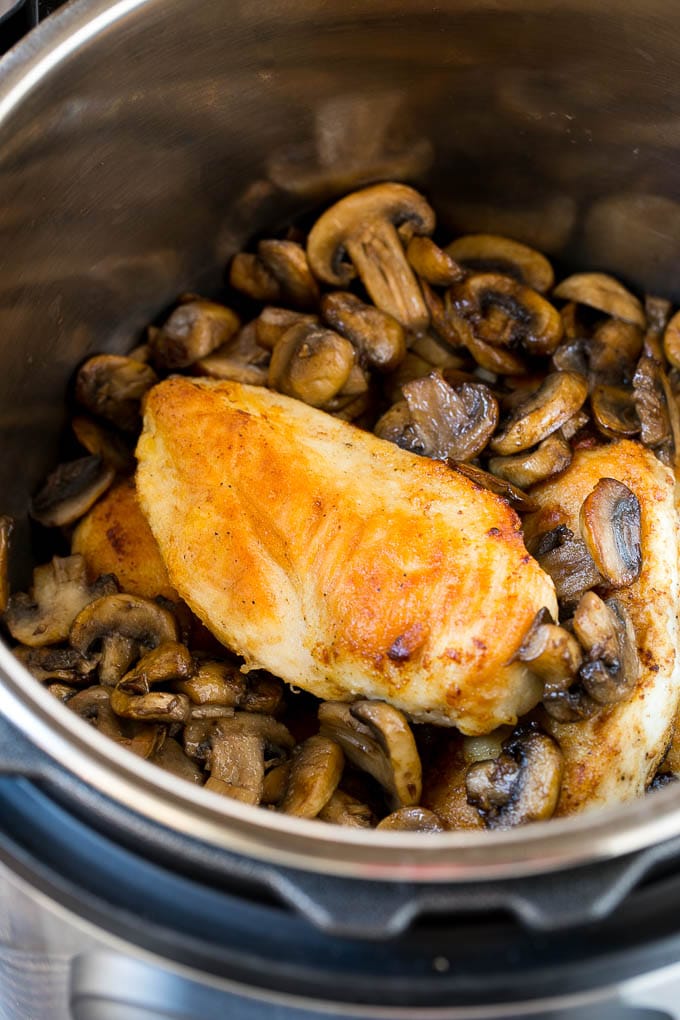 Chicken breasts and sauteed mushrooms in an Instant Pot.
