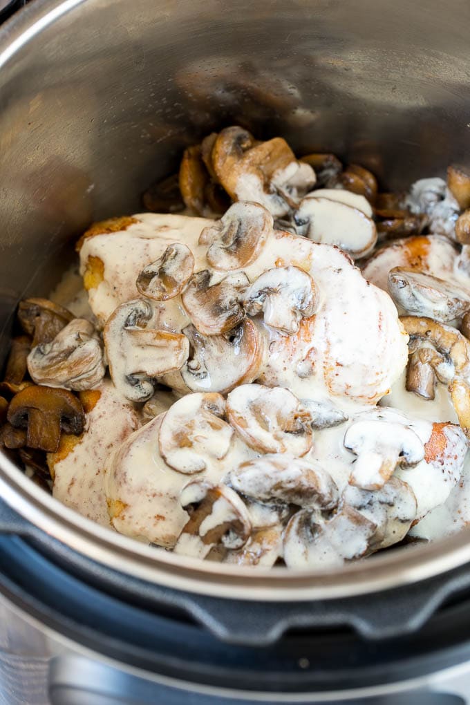 Chicken breasts with sauteed mushrooms and creamy sauce in an Instant Pot.