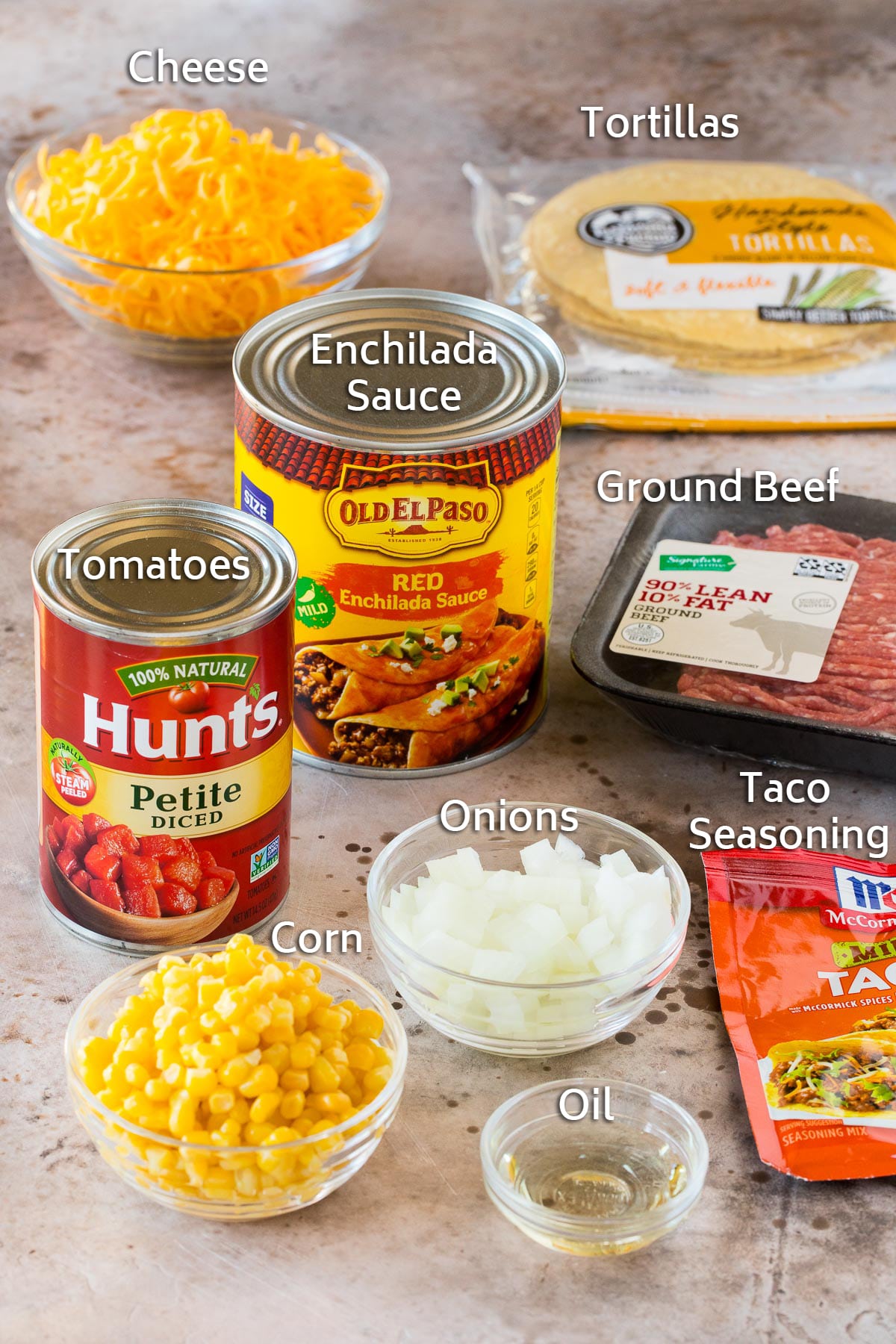 Ingredients including ground beef, tortillas, vegetables and seasonings.