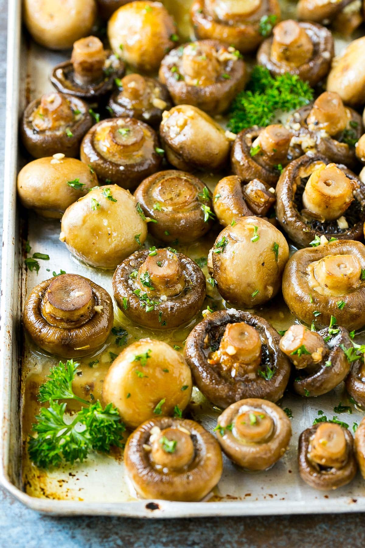Roasted mushrooms on a pan garnished with parsley.