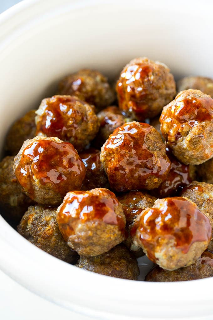 Meatballs in a slow cooker coated in sweet and sour sauce.