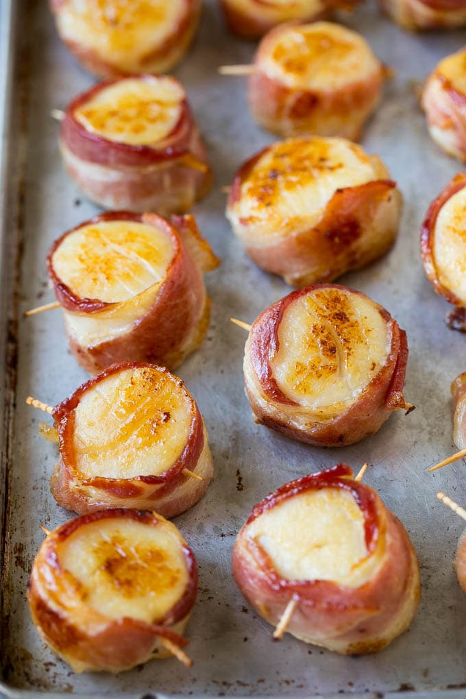 Broiled bacon wrapped scallops.