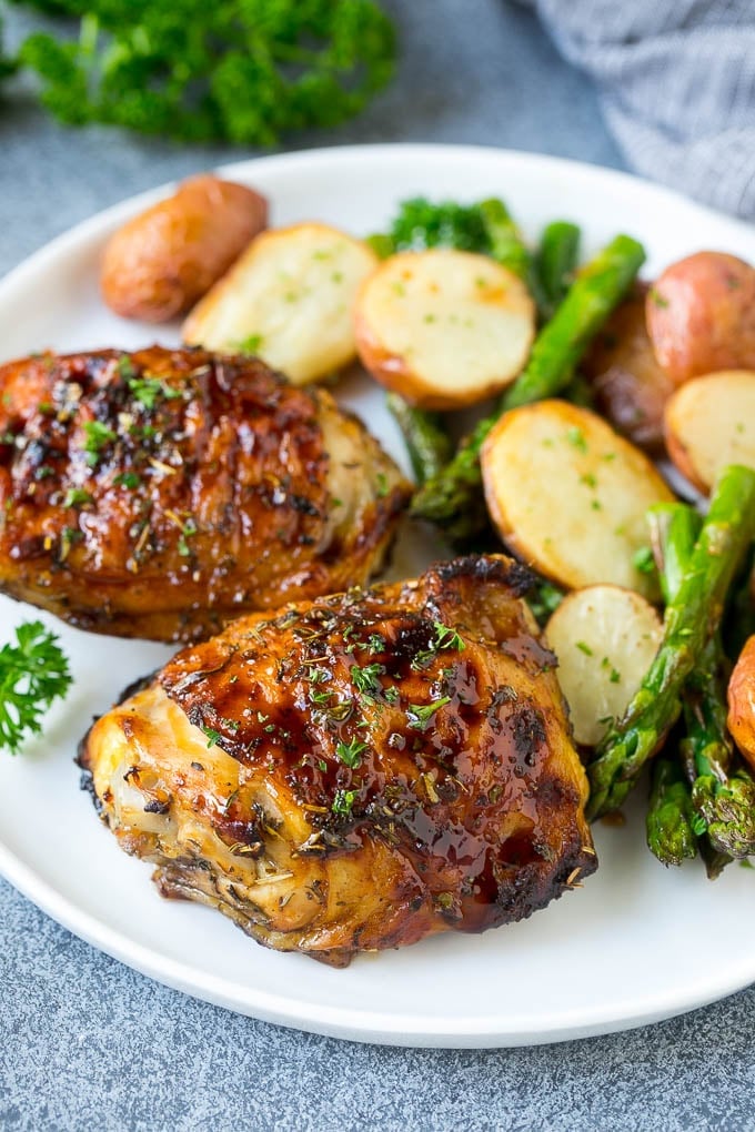 Balsamic chicken, potatoes and asparagus on a serving plate.