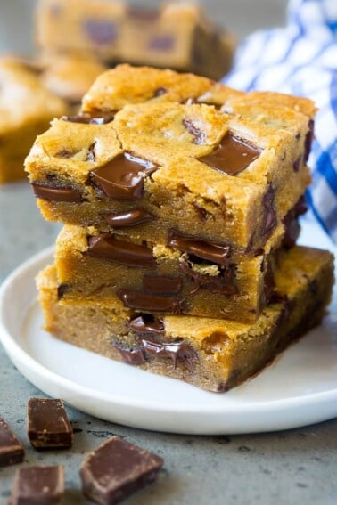 A stack of blondies loaded with dark chocolate.