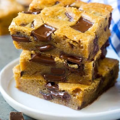 A stack of blondies loaded with dark chocolate.