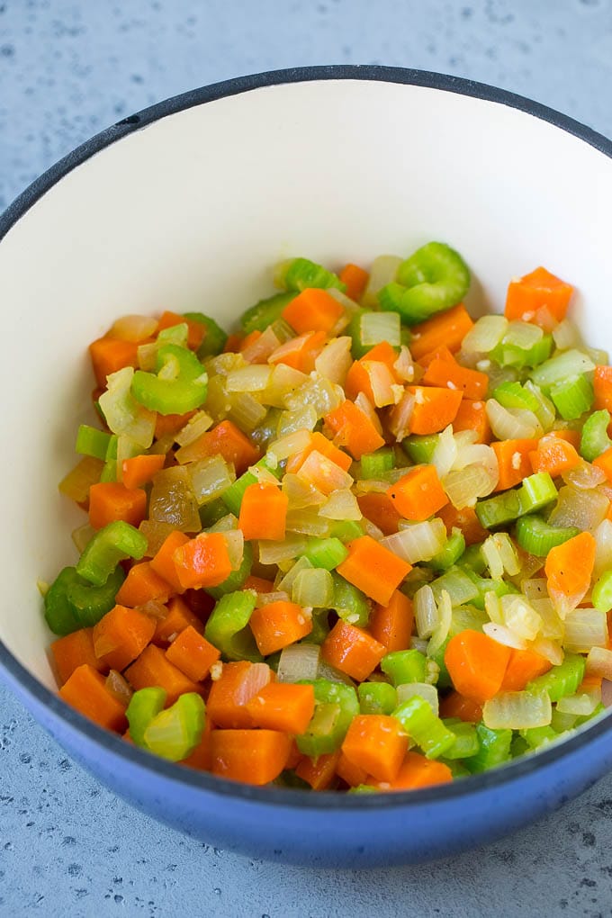 Carrots, onions and celery in a soup pot.