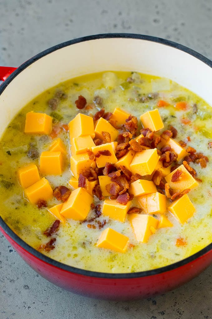 Cheeseburger Soup Recipe | Hamburger Soup | Cheese Soup #soup #groundbeef #hamburger #cheese #bacon #dinner #dinneratthezoo Potato soup base with cubes of Velveeta cheese and bacon being stirred in.