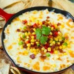 Hot corn dip made with two types of cheese, corn, peppers and bacon, served with tortilla chips.