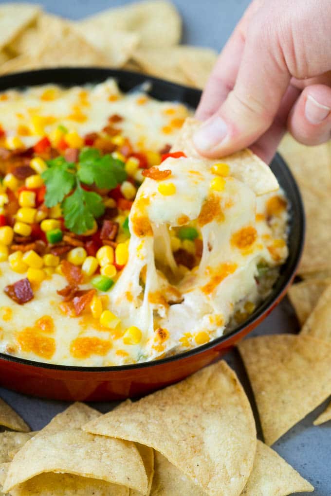 A chip scooping up a serving of corn dip.