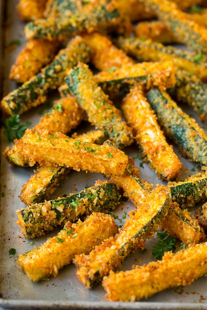 Fried zucchini sticks on a sheet pan.