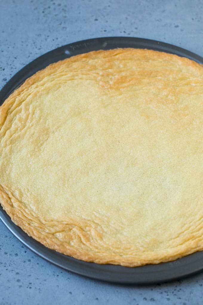 A sugar cookie baked inside a pizza pan.