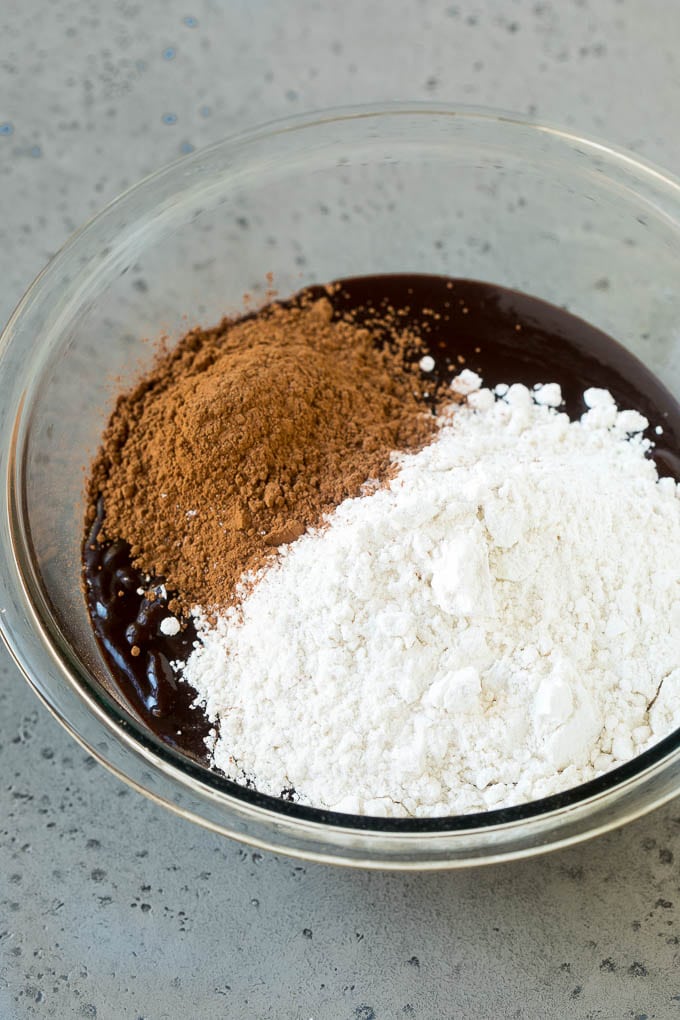 Melted chocolate, sugar, cocoa powder and flour in a mixing bowl.