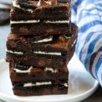 A stack of Oreo brownies filled with sandwich cookies and chocolate chips.