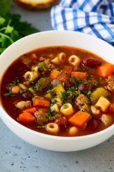 A bowl of pasta e fagioli soup with colorful veggies, ditalini pasta, two types of beans and ground beef.