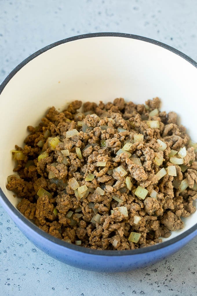 Ground beef and onions cooked in a soup pot.