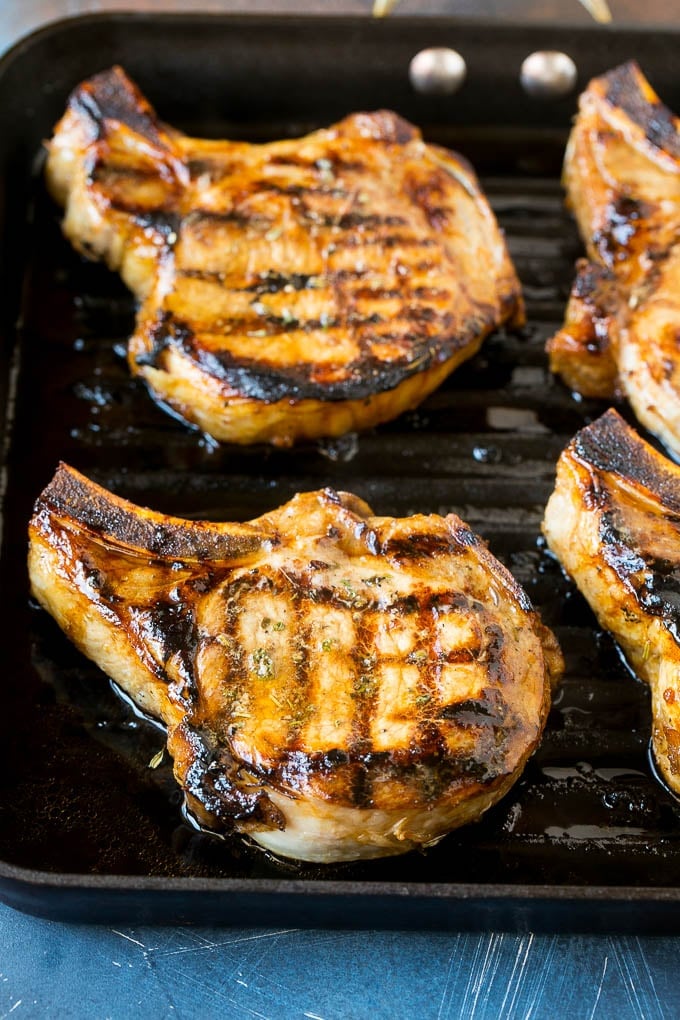 Marinated pork chops on a grill pan.