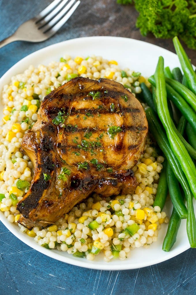 Pork chop marinade with grilled pork chops served over couscous with green beans.