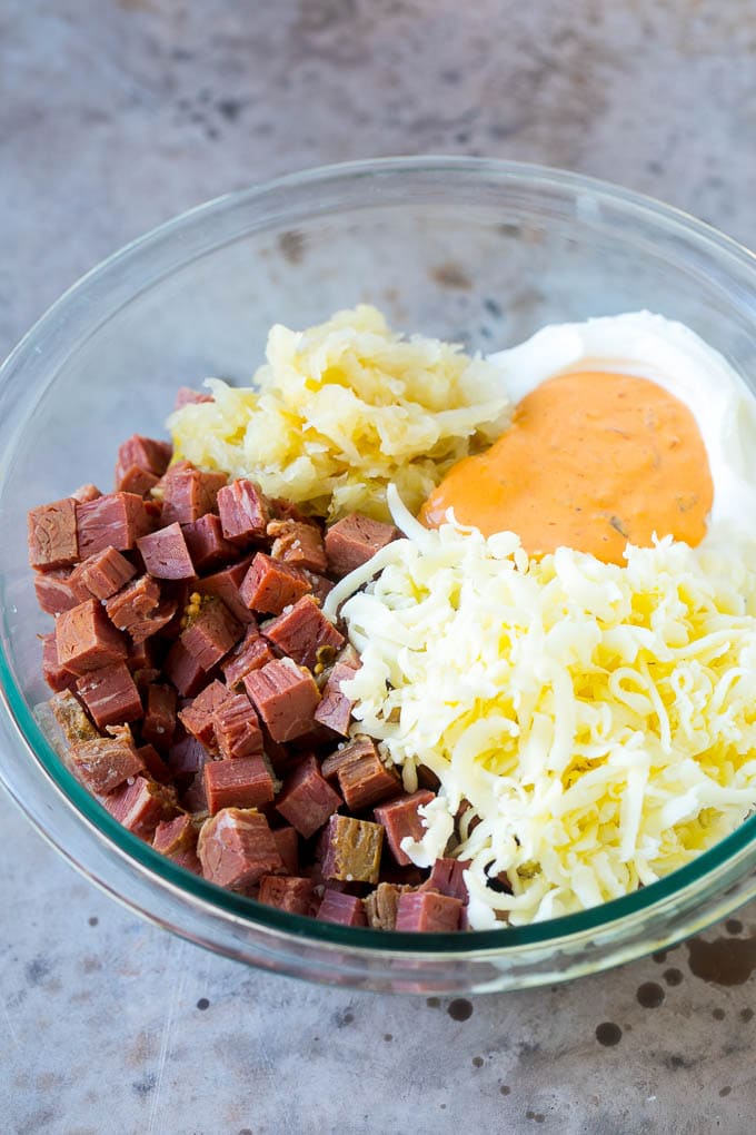 Corned beef, cream cheese, Thousand Island dressing and cheese in a bowl.