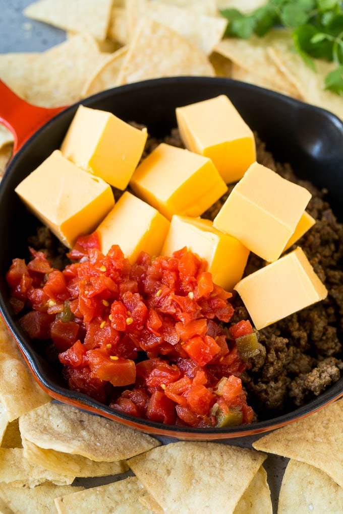 Ground beef, Velveeta cheese and Rotel tomatoes in a skillet.