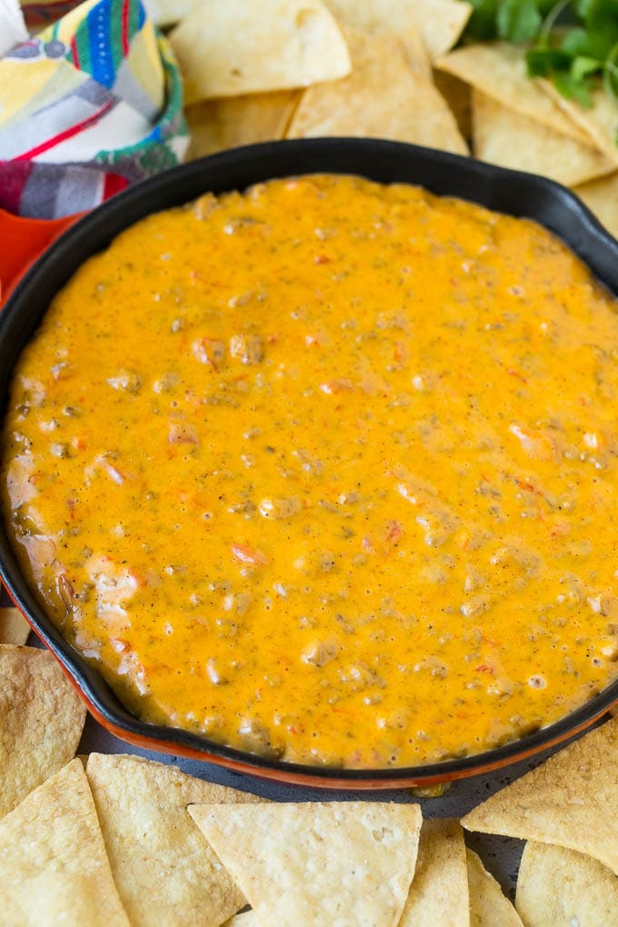 A skillet of Rotel dip surrounded by tortilla chips.