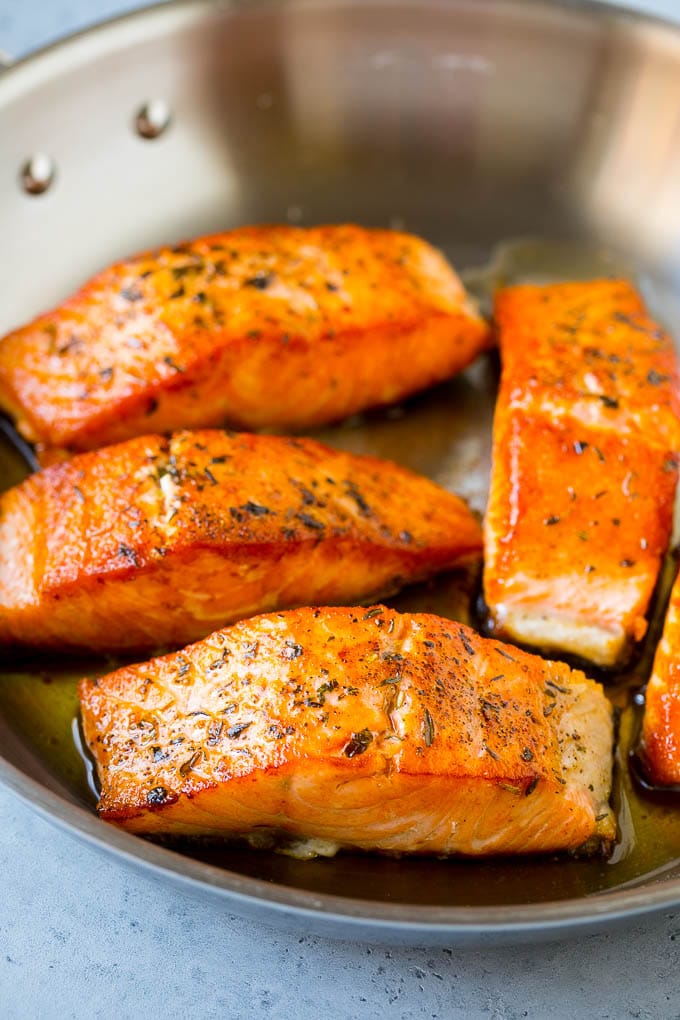 Seared fish fillets in a skillet.