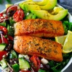 Salmon salad made with seared salmon fillets, vegetables, avocado olives and feta cheese.