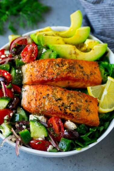 Salmon salad made with seared salmon fillets, vegetables, avocado olives and feta cheese.