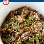 This slow cooker Korean beef is flank steak simmered with soy sauce, sesame oil, brown sugar, garlic and ginger in a crock pot.