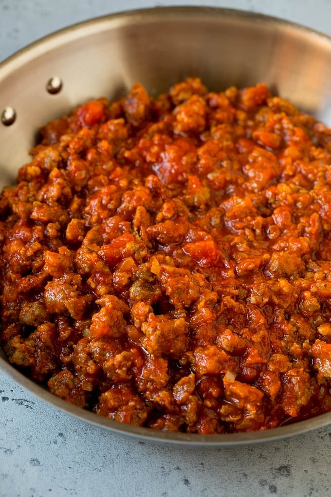 Sausage and tomato sauce in a skillet.