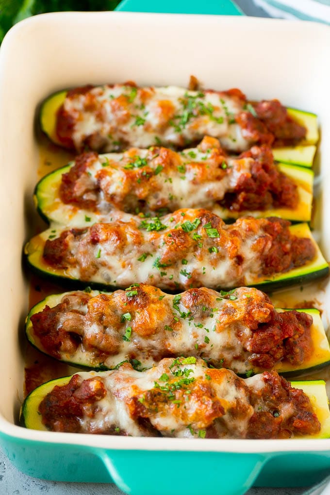 Stuffed zucchini boats filled with meat sauce and topped with melted cheese.