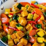 Tofu stir fry with peppers, carrots and zucchini in honey garlic sauce.