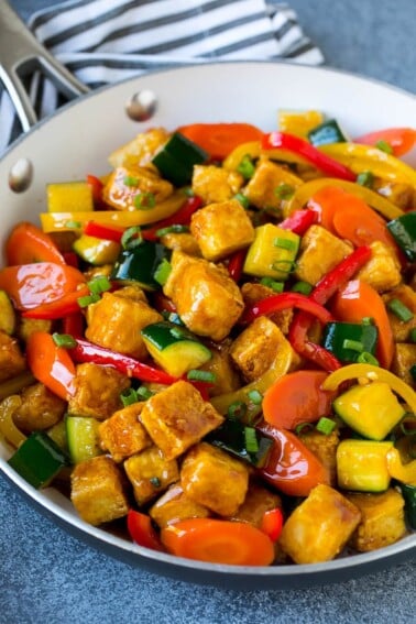 Tofu stir fry with peppers, carrots and zucchini in honey garlic sauce.