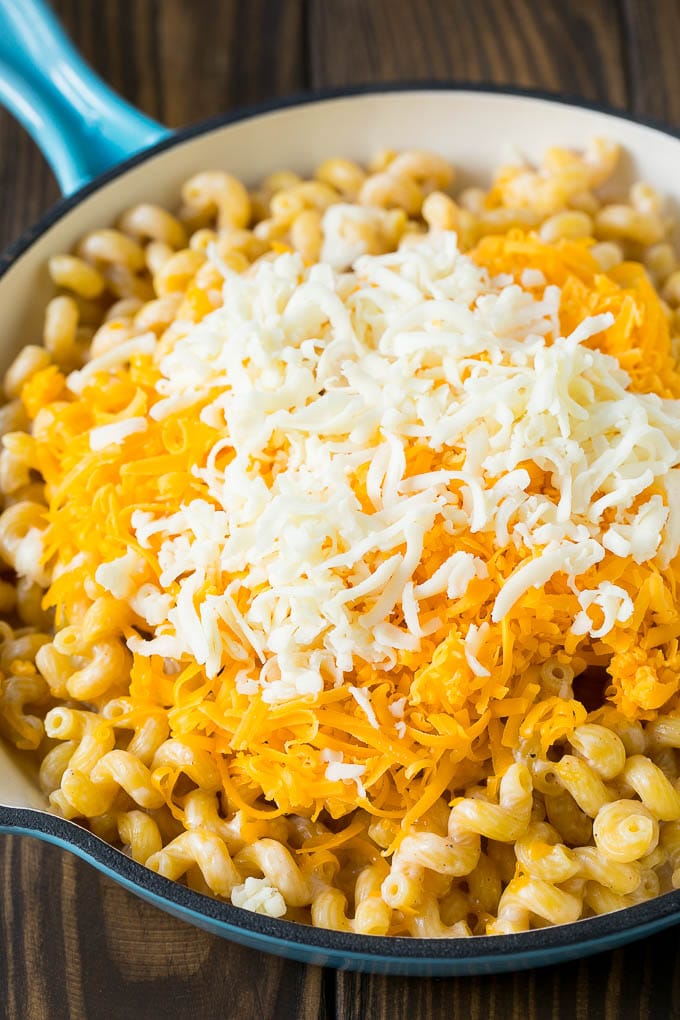 Noodles topped with two types of shredded cheese.