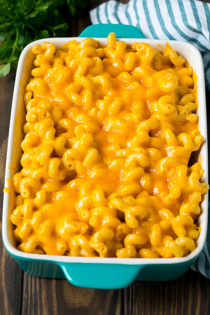 Baked mac and cheese in a blue casserole dish.