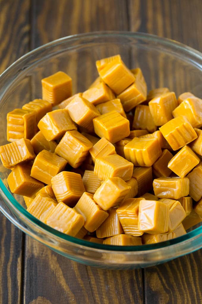 Unwrapped caramels in a mixing bowl.