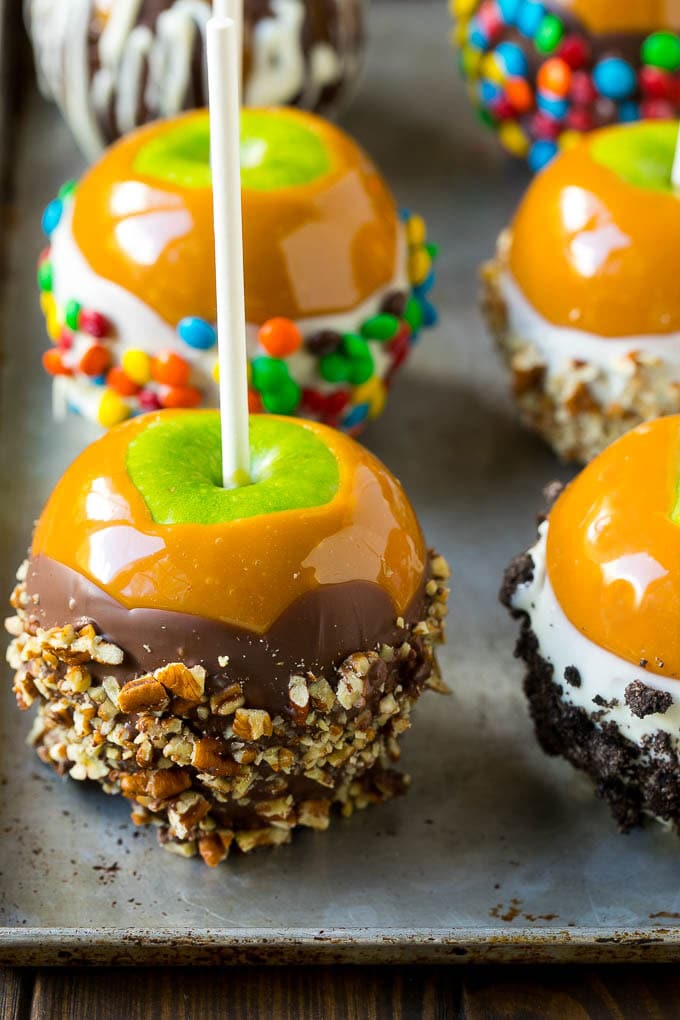 Caramel apples dipped in caramel, chocolate and coated with colorful toppings.
