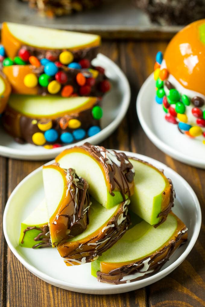 Sliced caramel apples on a plate.