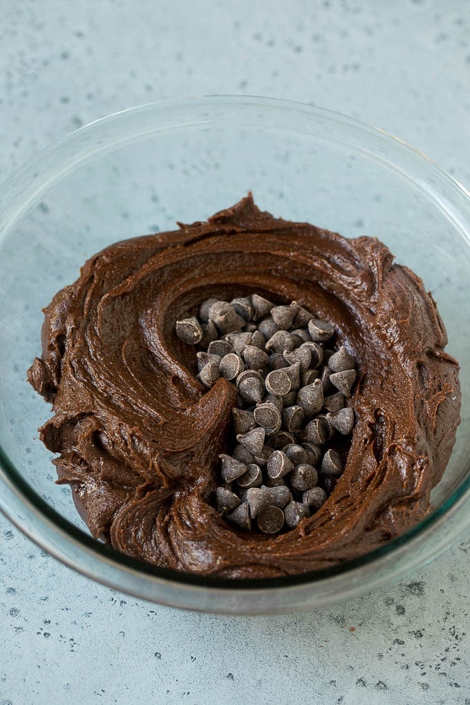 Brownie batter and chocolate chips in a mixing bowl.