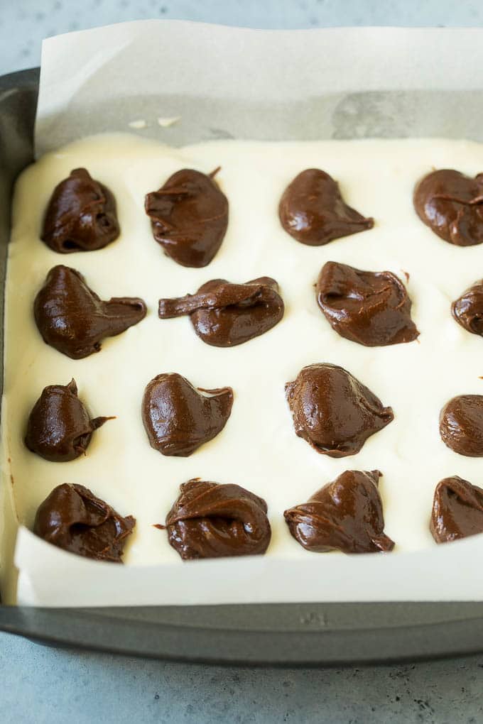 Cheesecake Brownies Recipe | Cream Cheese Brownies | Homemade Brownies #brownies #cheesecake #chocolate #dessert #dinneratthezoo Brownies topped with a layer of cheesecake and dollops of chocolate batter.