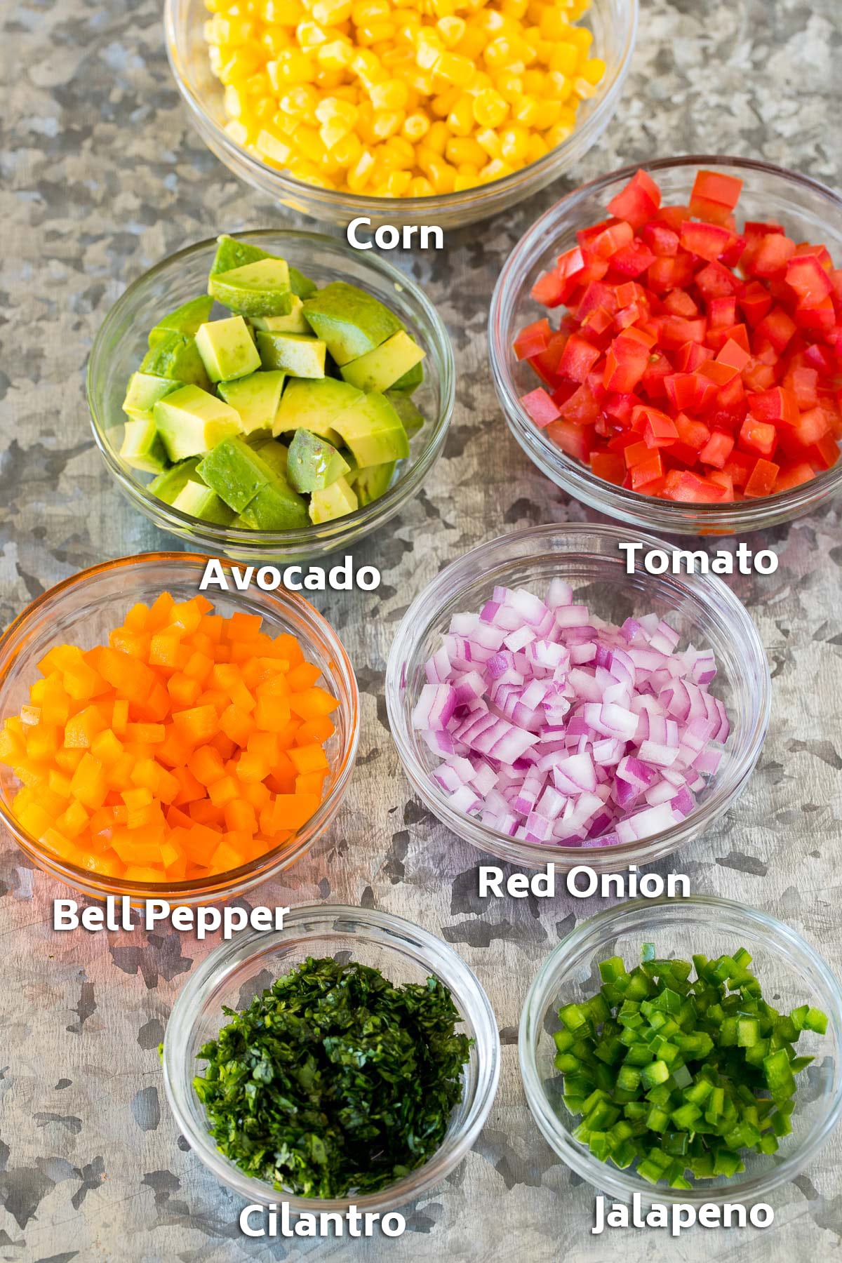 Bowls of assorted chopped vegetables.