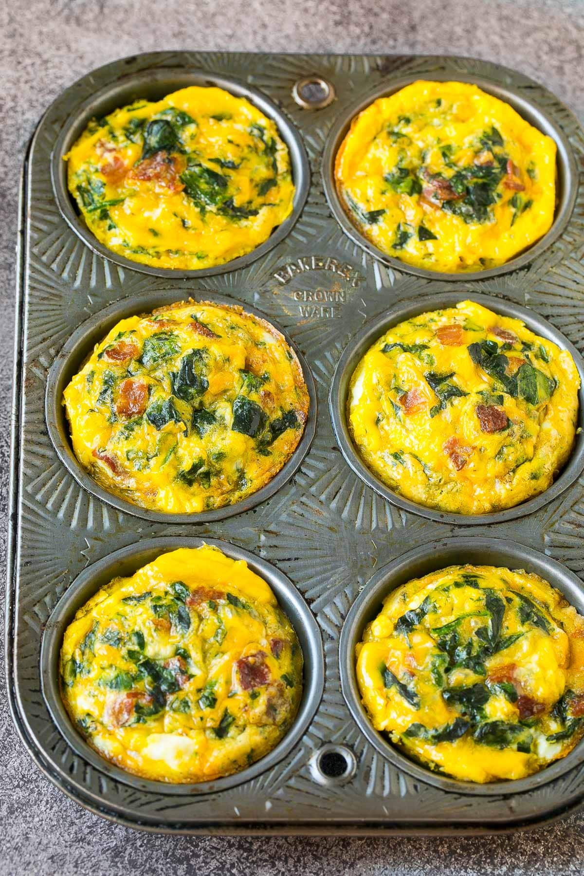 Cooked egg cups in a muffin tin.