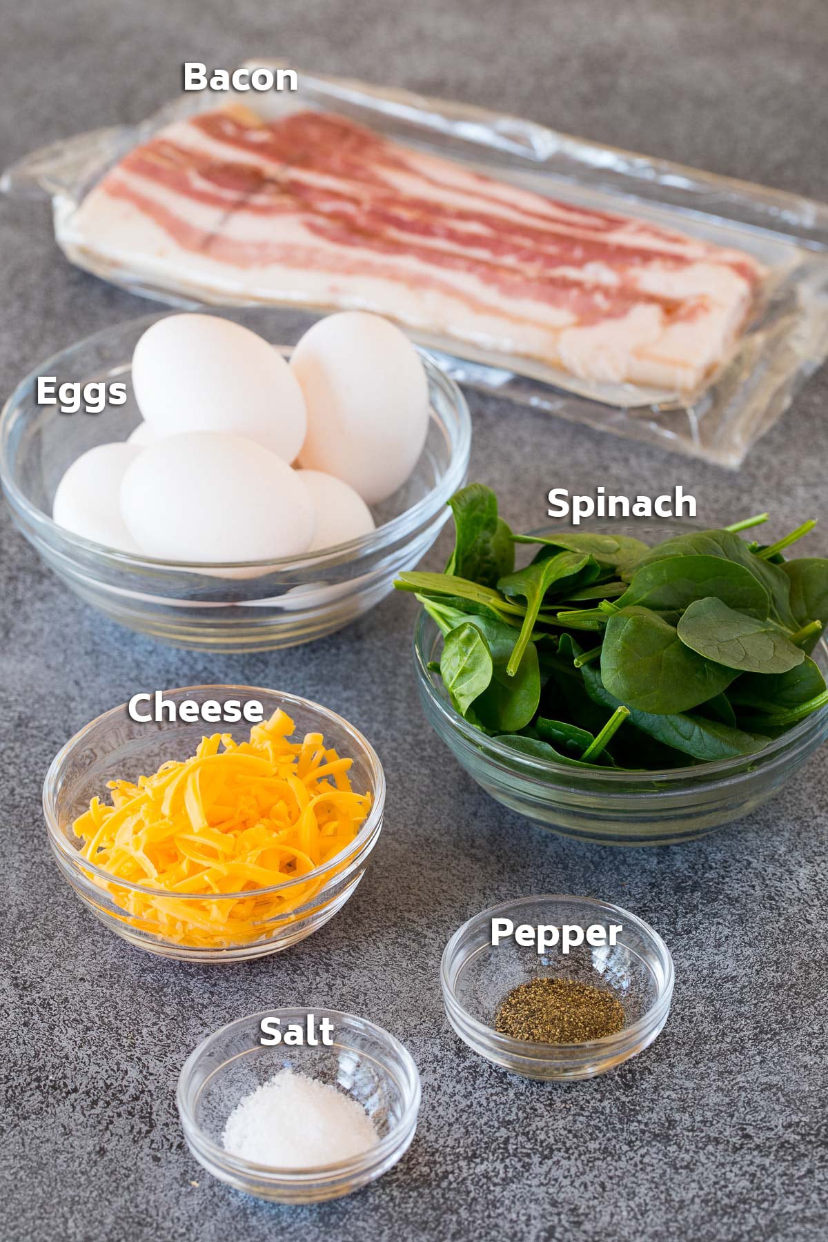 Ingredients including eggs, spinach, cheese and seasonings.